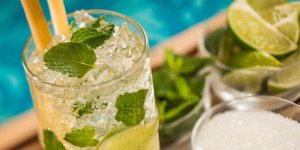 A mint filled mojito cocktail with limes